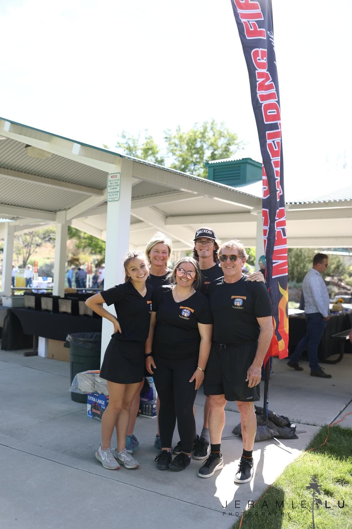 The Men Wielding Fire team gathered at a catered event