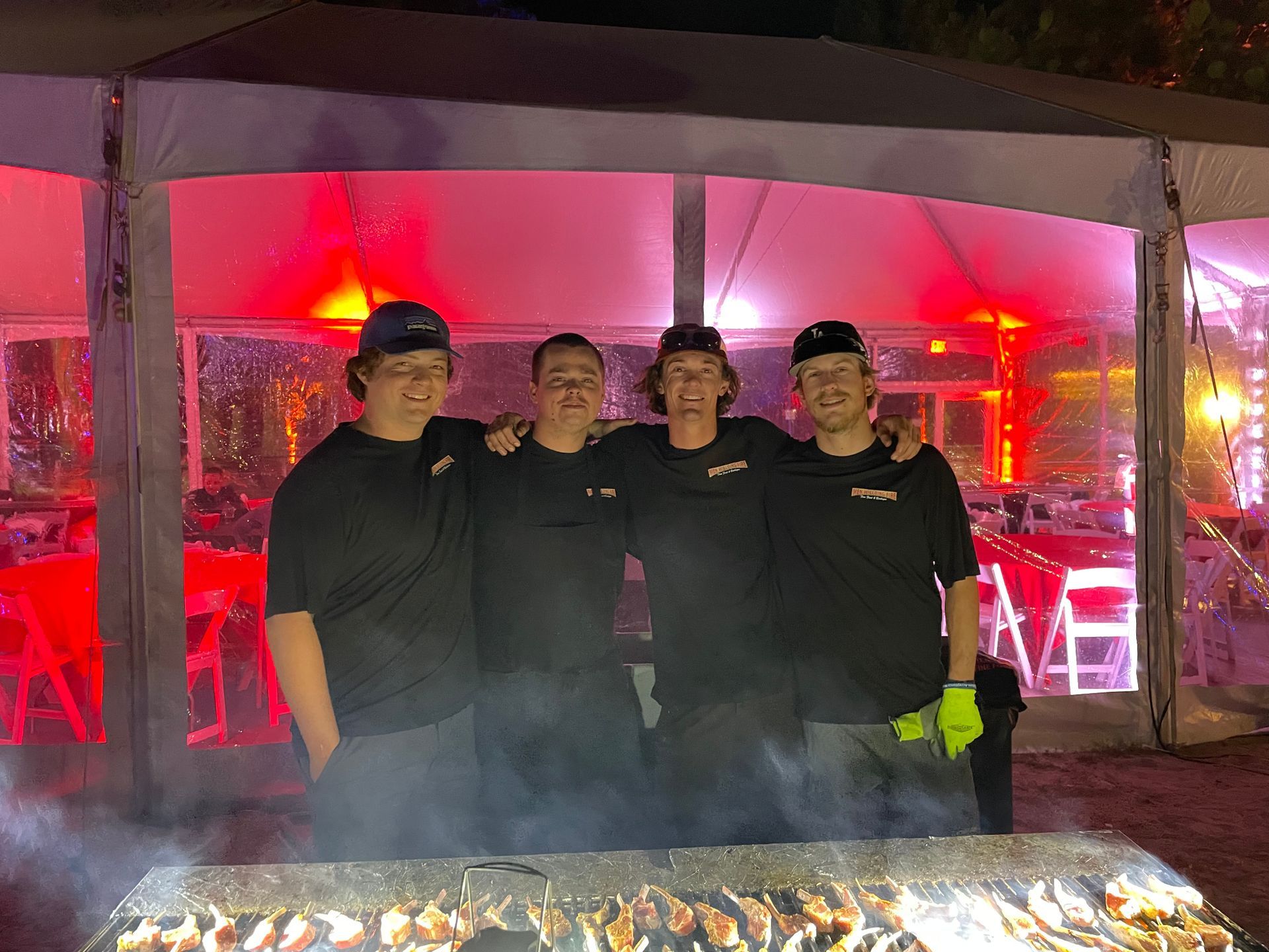 The Men Wielding Fire crew cooking at a nighttime event